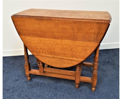 OAK GATE LEG DINING TABLEwith shaped drop flaps, standing on turned supports, 91cm wide 