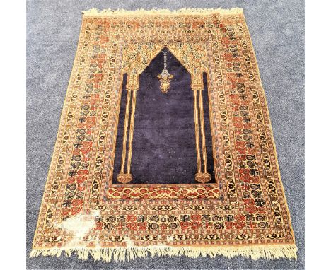 BOKHARA SILK AND WOOL PRAYER RUGwith a central navy blue ground with twin gold pillars, encased by a multi layered border, fr