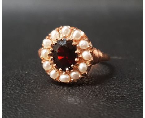 GARNET AND PEARL CLUSTER RINGthe central oval cut garnet approximately 1ct in twelve pearl surround, on nine carat rose gold 