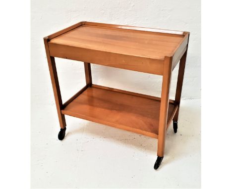 TEAK TEA TROLLEYwith a rectangular top above two two pull out shelves above a lower shelf, on casters, 69cm high 