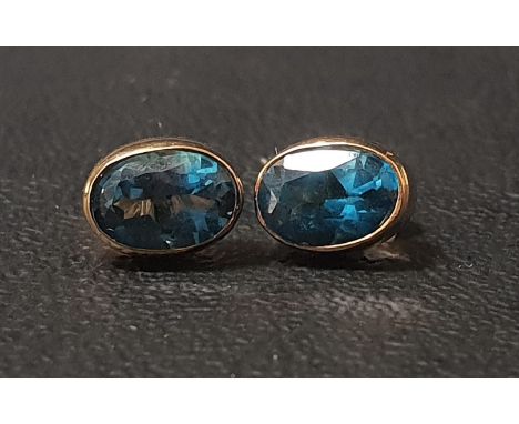 PAIR OF BLUE TOPAZ STUD EARRINGSthe oval cut topaz on each approximately 0.75cts, in nine carat gold 