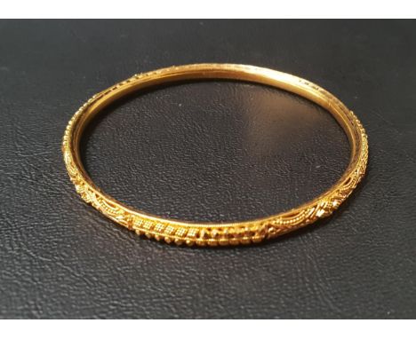 TWENTY-TWO CARAT GOLD BANGLEwith relief detail, approximately 9.9 grams 