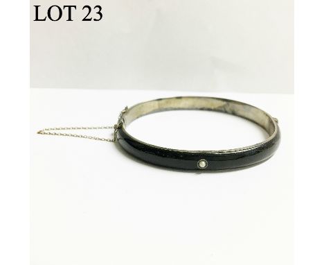 A Victorian enamel bangle set with a seed pearl in 800 silver