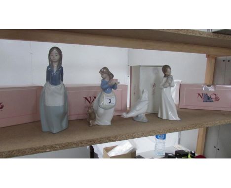 4 boxed NAO figurines