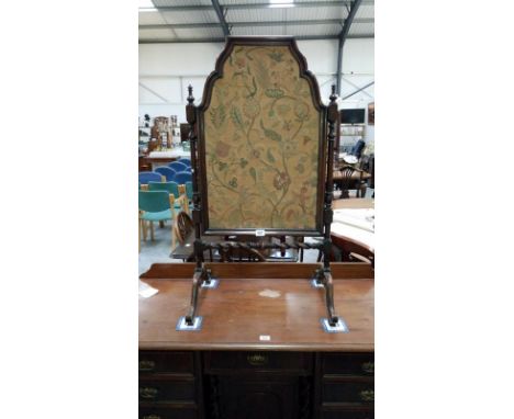 A Victorian mahogany fire screen with a tapestry insert