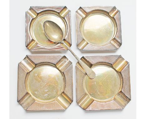 A set of four hallmarked silver ash trays and a hallmarked silver spoon, wt. 5oz.