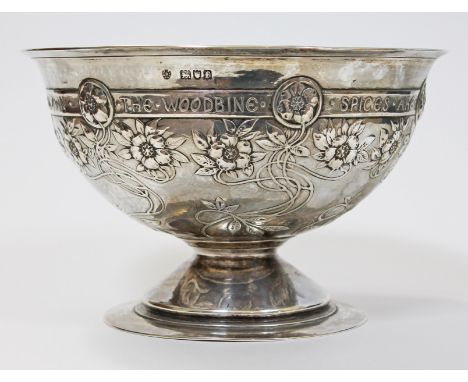 An Arts & Crafts hammered silver bowl decorated with roses and having Alfred Tennyson quote; 'The Woodbine Spices Are Wafted 