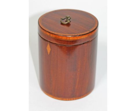 A George III crossbanded mahogany tea caddy of cylindrical form having gilt brass handle and inlaid imitation escutcheon, dia