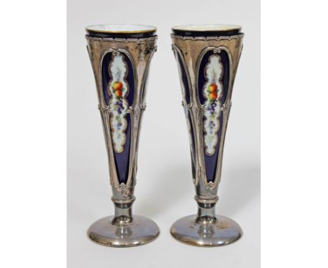 A pair of Royal Worcester conical vases decorated with panels of bouquets and fruit within gilt border on blue ground housed 