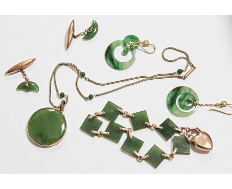 A suite of nephrite jade jewellery comprising a yellow metal mounted round pendant necklace marked '9ct', a locket bracelet a