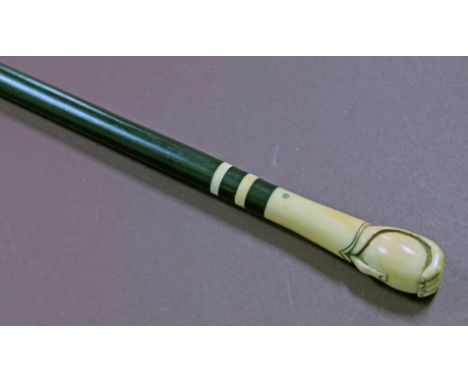 A carved ivory and ebony walking stick circa 1900, length 91.5cm.