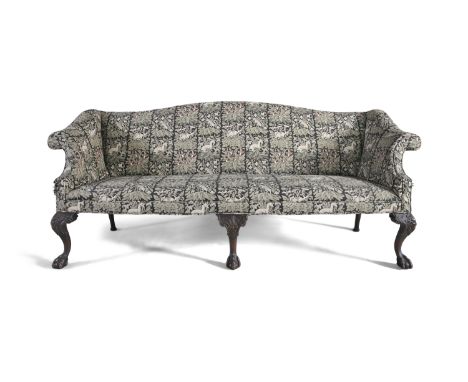 A 19TH CENTURY MAHOGANY FRAMED UPHOLSTERED CAMEL BACK SOFA, in the mid-Georgian Chippendale taste, covered in New Forest patt