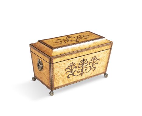 A REGENCY 'BIRDSEYE' INLAID MAPLE TEA CADDY, of sarcophagus form, the top and front inlaid with foliate motif, and the edges 