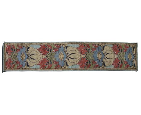 A MODERN WOOL RUNNER AFTER A DONEGAL DESIGN ATTRIBUTED TO C.F. VOYSEY, the central field woven with floral pattern in the Art
