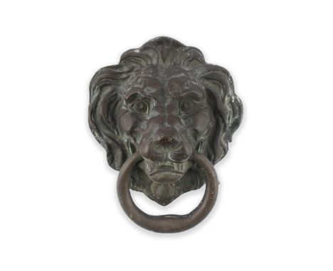 A LARGE GEORGIAN CAST BRASS DOOR KNOCKER, in the form of a lion's head, with ring handles. 26 x 18cm