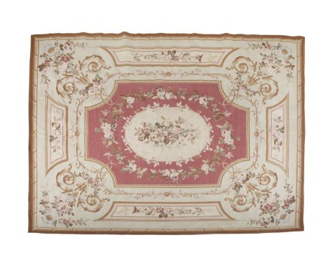 AN AUBUSSON DESIGN TAPESTRY CARPET, 20th century the rose coloured centre ground with oval medallion filled and surrounded by