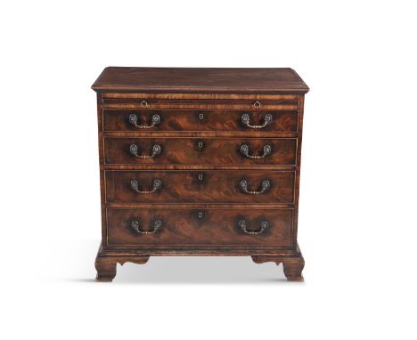 A GEORGE III MAHOGANY RECTANGULAR COMPACT CHEST OF DRAWERS, the top with thumb moulded rim above a pull-out brushing slide an