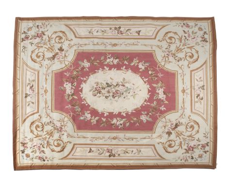 AN AUBUSSON TAPESTRY CARPET, 20th century the rose coloured centre ground with oval medallion filled and surrounded by chains