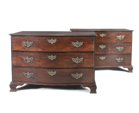A PAIR OF GEORGE III MAHOGANY SERPENTINE CHESTS, with shaped tops above three long graduated drawers, fitted with pierced bra