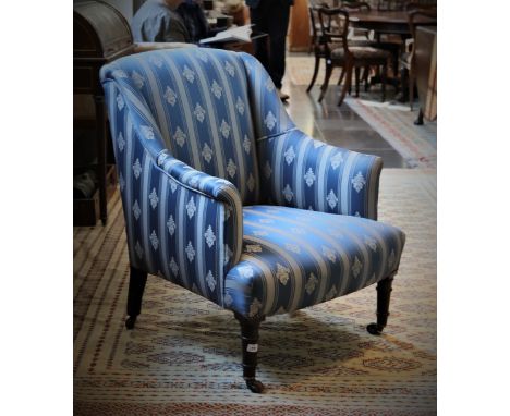 A GEORGE IV UPHOLSTERED WING ARMCHAIR, on ring turned mahogany legs and brass castors, stamped with serial number