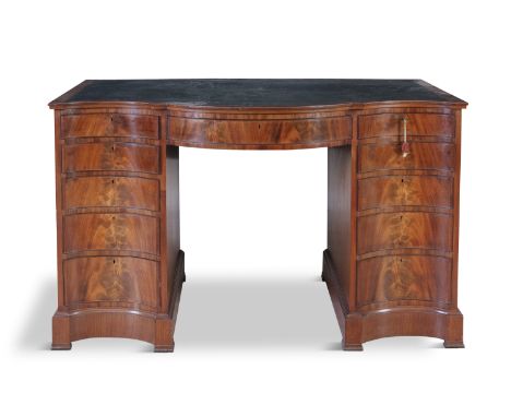 A GEORGE III FLAME MAHOGANY SERPENTINE FRONT LIBRARY KNEEHOLE DESK, the top inset with leather scriver, with single frieze dr