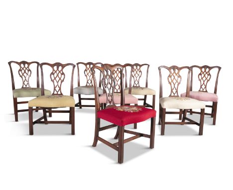 A SET OF EIGHT WALNUT FRAMED DINING CHAIRS IN THE CHIPPENDALE TASTE, with carved undulating crest rails above pierced and car
