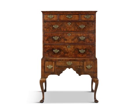 A GEORGE II WALNUT CHEST ON STAND, the upper section with cavetto cornice, three short and three long graduated drawers, with