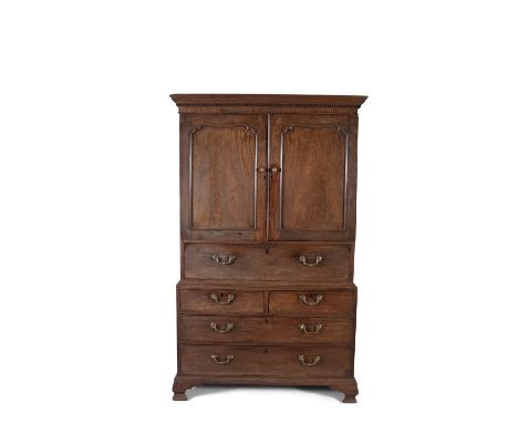 AN IRISH GEORGE III MAHOGANY LINEN PRESS, with moulded dentil cornice, above twin fielded cupboard doors, enclosing pull-out 