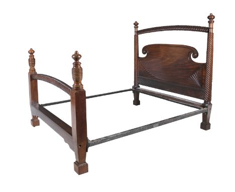 AN EARLY 19TH CENTURY IRISH MAHOGANY FRAMED DOUBLE BED, probably Cork, the headboard with carved quarter patterae, surmounted