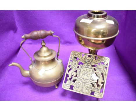 An antique brass cast fire trivet or kettle stand having French coat of arms also kettle and lamp base