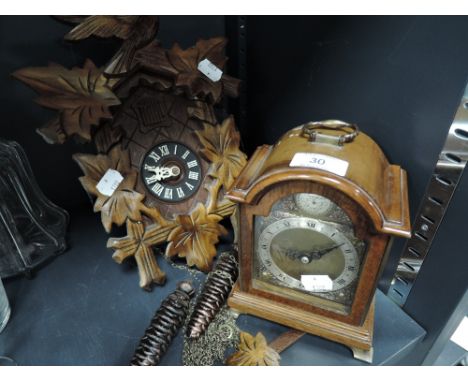 Two clocks including wall mounted German style cuckoo clock and Tempus Fugit mantle clock