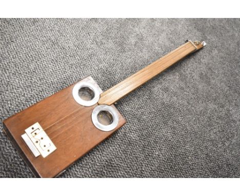 A cigar box style guitar, three string