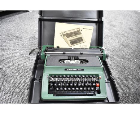 A silver Reed typewriter in case