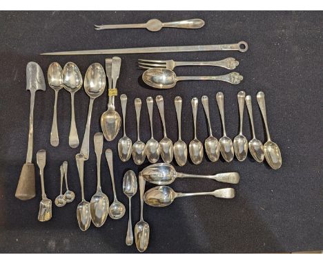 A collection of silver flatware to include a meat skewer, sugar scoop, lobster fork and multiple teaspoons, mostly Georgian, 