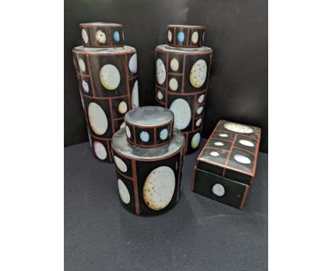 A collection of ceramic containers depicting exotic eggs
