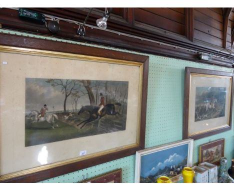 A pair of prints after George La Porte, each of 19th century hunting scenes, 30cm x 55cm in glazed wooden frames.