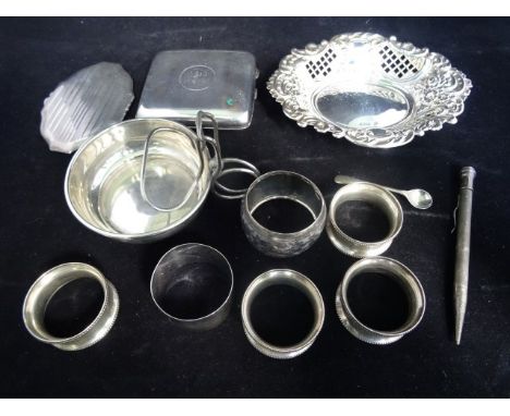 A quantity of silver items to include: a cigarette case, a lady's powder compact, six napkin rings, a self propelling pencil 