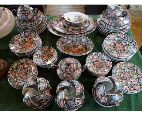 An extensive 20th century Chinese dinner service, decorated profusely with floral arrangements on a black ground, comprising 