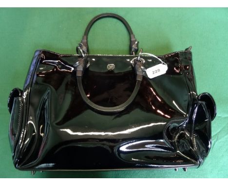A ladies Anya Hindmarch black patent leather handbag, having suede lined interior, two internal compartments with single zip 