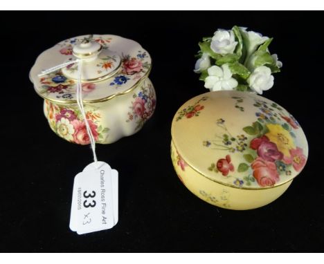 A Royal Worcester blush ivory lidded pot, decorated with hand painted floral spray, puce printed mark to base, date cypher 19