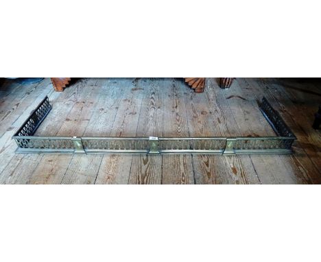 A late Victorian brass fender with pierced decoration, 132cm wide.
