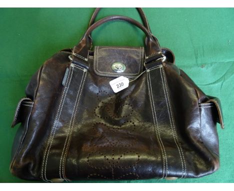 A ladies Orla Kiely brown leather handbag, having three internal pockets (one zipped), two external pockets, clasped closing 