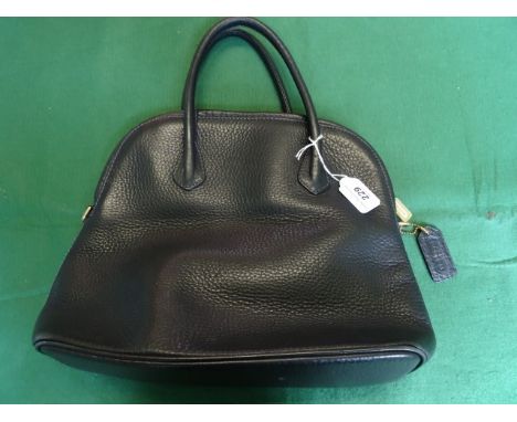 A ladies Coach black leather handbag, having internal zipped pocket, single zip opening with two leather handles.  Original d
