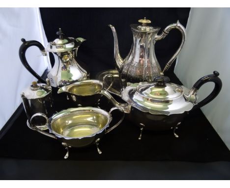 A silver plated teapot with ebony loop handle on four splayed supports, together with a matching coffee pot, cream jug and tw