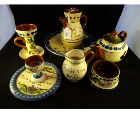 A collection of Devon Mottoware pottery, to include examples from Longpark, together with a Continental ceramic dish of simil