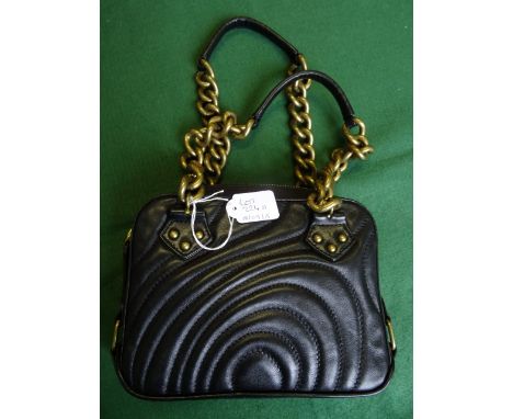 A small ladies Paul Smith black leather handbag, having internal pocket, single zip opening and twin gilt metal and leather h