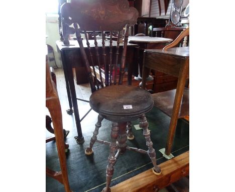 An 18th century stick back chair with height adjustable seat on four turned legs, united by cross stretcher and metal and gla