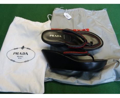 A pair of ladies Prada wedged heeled toe-post sandals, with red stitched detail, size 38.5, with original dust bag and carry 