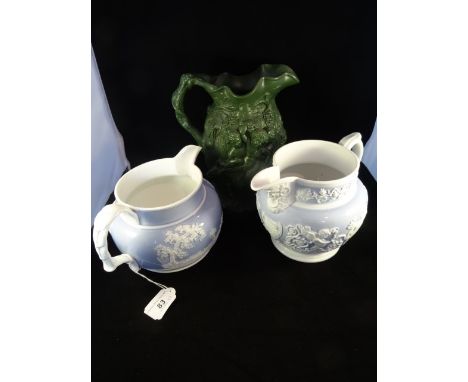A Minton Bacchus relief decorated green water jug, marked no. 19, 23cm, together with two lilac ground jugs, one decorated wi