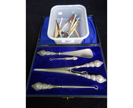 A collection of eight bone lace making bobbins, typically decorated with names, together with a silver plated cased set to in